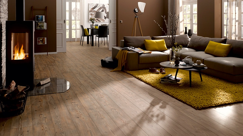 bodenbelag-avatara Avatara Designboden in authentischer Holzoptik im Wohnzimmer mit Kamin und moderner Einrichtung.