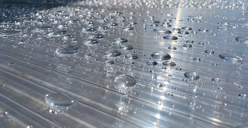 überdachungen-stegplatten-regentropfen Überdachungen - Stegplatte mit Regentropfen – Nahaufnahme einer Überdachung bei Regenwetter.